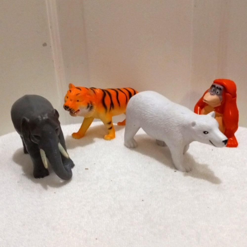 4 Jungle Animals Approx 5" long, hard plastic.